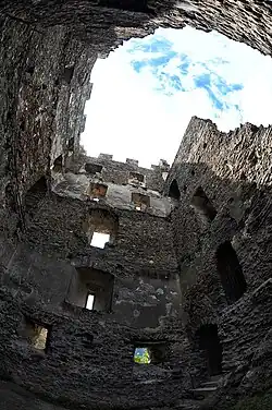 Partially destroyed stone tower. One can slightly guess the different floors that have now disappeared.