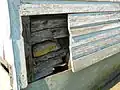 Log structure beneath the siding