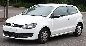 Front-three-quarter view of a small three-door car with a two-box body style fitted with door mirrors, body-coloured bumpers, flush headlamps, and hubcaps.