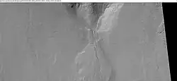 Close-up of a gully showing a channel going across the apron, as seen by HiRISE under HiWish program. Note: this is an enlargement of a previous image from Arkhangelsky Crater.