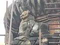 A broken statue of a lion carved on the top of Yameswar Temple