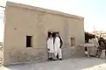 Two Sindhi muslim men wearing Sindhi Salwar Khamis and Godd with Sindhi rumals (handkerchiefs)