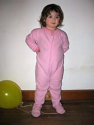 Toddler in footed pyjamas.