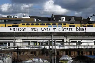 Anarchist graffiti on the train line leading to Central Station in Amsterdam