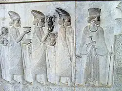 Similar armlets in the "Apadana" reliefs at Persepolis, also bowls and amphorae with griffin handles are given as tribute