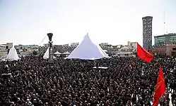 A crowd of mourning men in black clothing