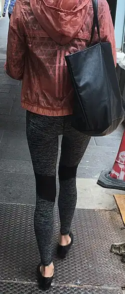 Athleisure fashion, 2017, with athletic bottoms and sneakers worn as casual streetwear by women and men alike.