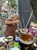 A lady preparing bún bò Huế at Dong Ba Market, Huế