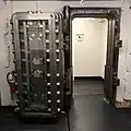 The first floor retail tenants share a men's restroom which was converted from the former bank vault, still with the vault door.