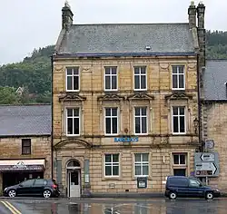 Barclays Bank, the building stands at the junction of Bridge Street and Town Foot (B6341).