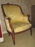 A bergère, which has full armrests.
