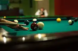 A player is preparing for a shot in 8-ball