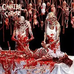 a zombie butcher pulls a stillborn corpse from a half-skeletonized dead woman while another stabs her torso. Dead babies in various states of decay are behind them.