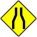 Road narrows on the both sides