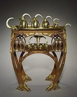 Color photograph of a tea table, with tea and coffee service, and salver.