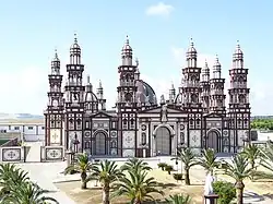 A white and brown cathedral under a clear sky