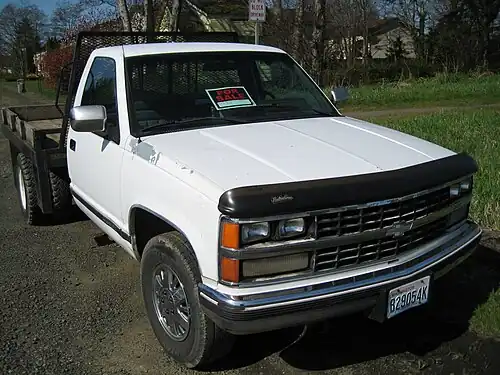 Dually Chevrolet flatbed with dual wheels on the rear axle for improved towing.