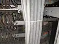 Cables laced together in a bundle using a Chicago stitch. In this case, the cables are not secured to a structure, but the cable lacing is used to keep them in a rectangular form in the riser.