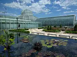 A one-story glass conservatory during daytime