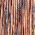 Close-up of a weathered yakisugi façade showing charred wood texture and grain contrast