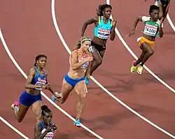 Ta Lou-Smith running around a bend in lane 4