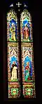 Ulisse De Matteis, stained-glass window depicting saints Joseph, Andrew, Vincent, and Margarita, transept of Prato Cathedral, 1870-71.