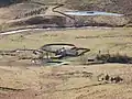 A farmstead standing between the river and a stream