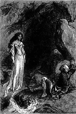 A standing woman and a seated man watching her