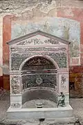 The apsidal temple-style mosaic fountain in the pseudo-peristyle