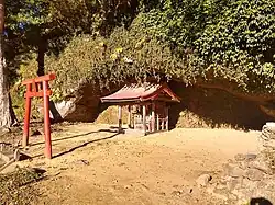 Small shrine inside a grottoe like cave.