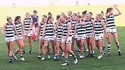 Group of female athletes walk from football oval after a game