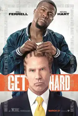 A man in a suit is getting his hair braided into cornrows