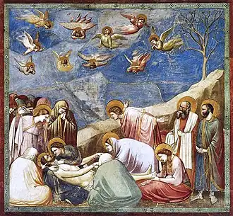 Giotto's Lamentation of Christ (1300s) fresco at the Cappella degli Scrovegni (Padova) has figures with their backs to the viewer.