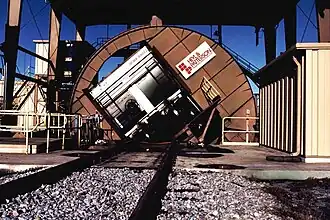 A rotary car dumper