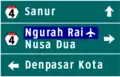 4-way directional sign. Ngurah Rai International Airport is highlighted in blue as it is a public facility