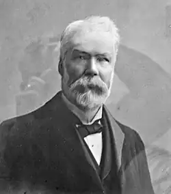 A black and white portrait of Scottish grocer James Robertson in 1874.