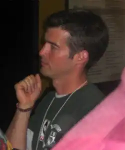An approximately 34-year-old man looking at something to the left of the camera.