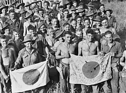 Soldiers of the Australian Army's 2/6th Independent Company display Good Luck Flags they captured during the Battle of Kaiapit on 26 September 1943