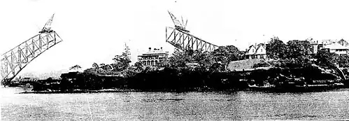 Kirribilli and Admiralty House with construction of the Sydney Harbour Bridge in the background, 1930