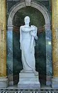 Statue of a man holding a sword and a book