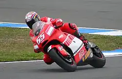 Loris Capirossi riding his Ducati Desmosedici GP5 in 2005 with an alternative red & black "barcode" livery.
