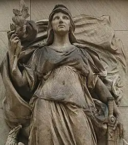 A colir photograph of a stone sculpture representing Victory