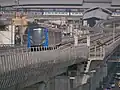 EMU-BLE approaching Bang Phai station with Tha Phra station in the background.