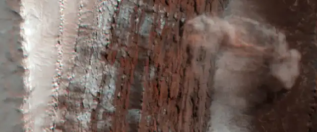 Dust clouds rise above the 700-metre (2,300&nbsp;ft) deep cliff.