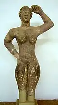 Beginning of CE sandstone-carved Meroitic statue raising its left arm