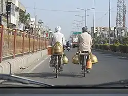 Milk vendor with typical traditional brass containers, called Gagar, used in the Majha region of Punjab
