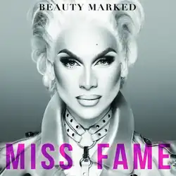A drag queen in full makeup staring in to the camera lens.