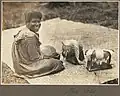 Moa Island (woman sitting on mat making lace)