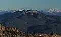 Northwest aspect of Mount Watson centered. Glacier Peak distant right. Snowking distant left.