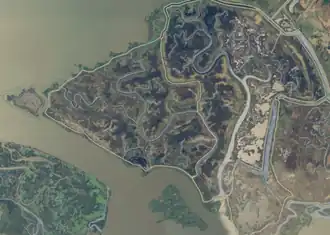 Sad-looking aerial photo of an island suffused with muck.